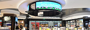 A large circular screen attracts the attention of travelers at the World Duty Free in Detroit